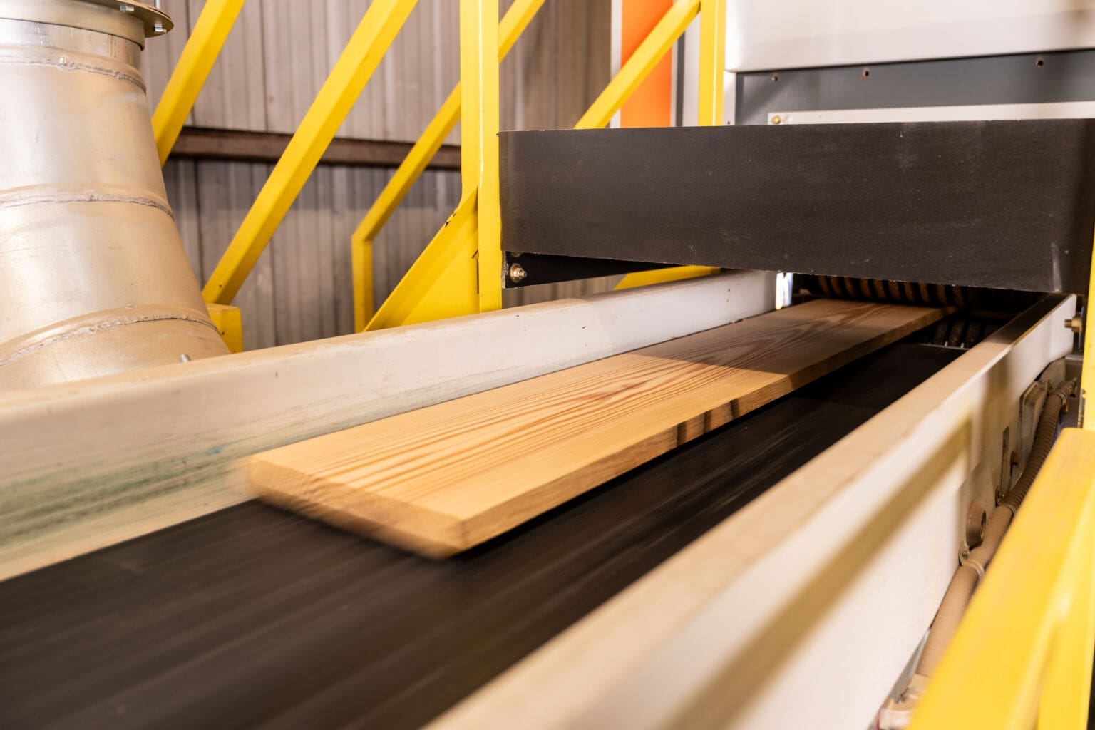 Wood boards moving through milling equipment