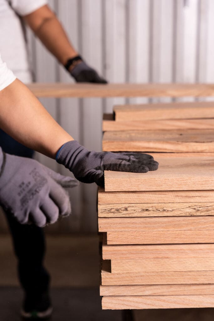 Gloved hands selecting boards