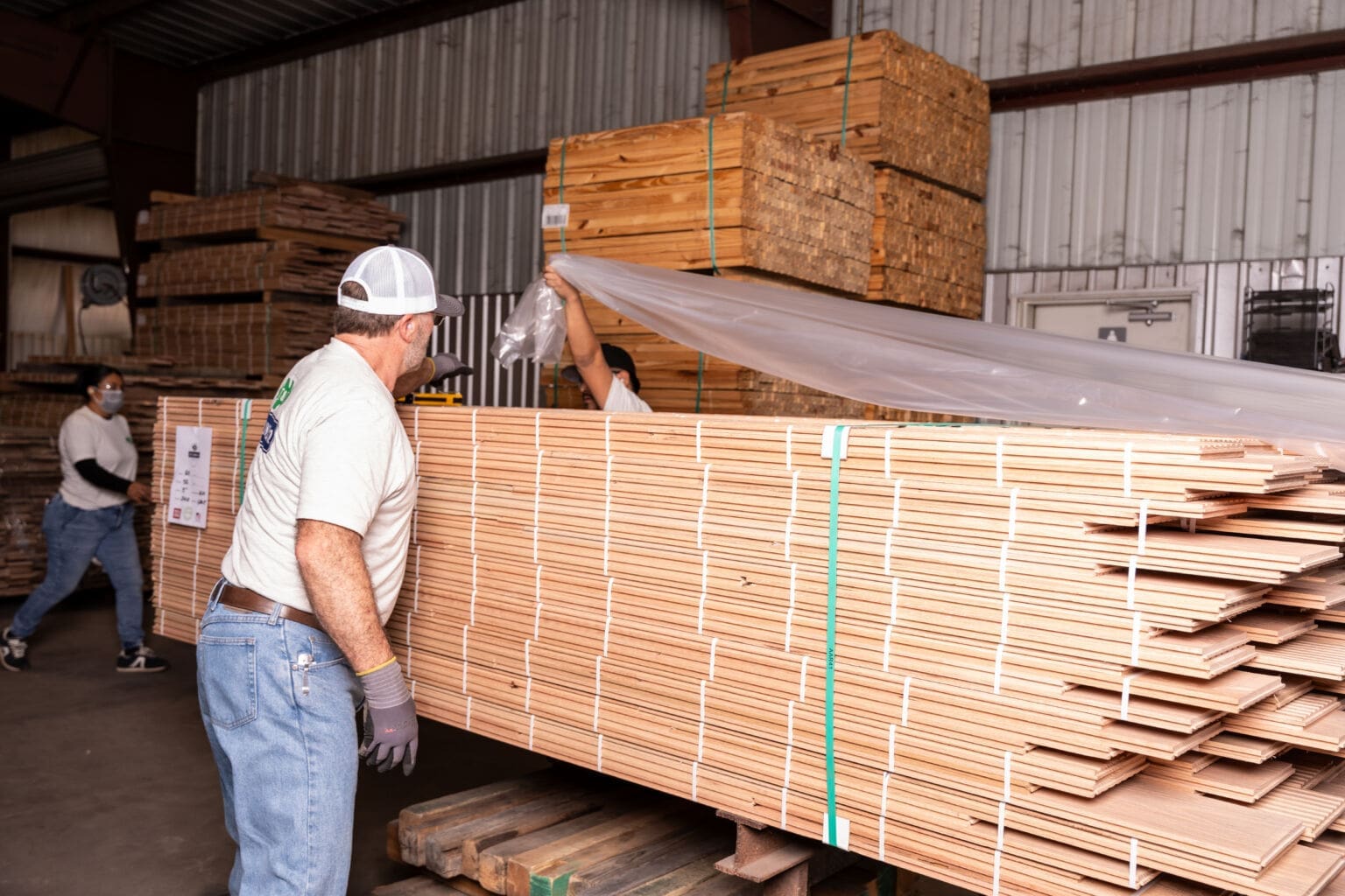 T&F Lumber craftsman with stacked lumber