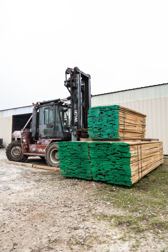 Forklift handling lumber at the facility